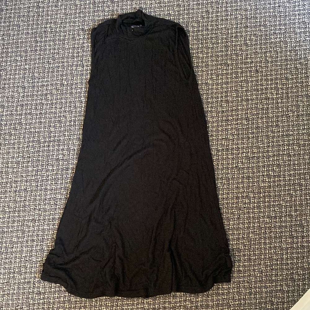Knee length high neck sleeveless black dress.